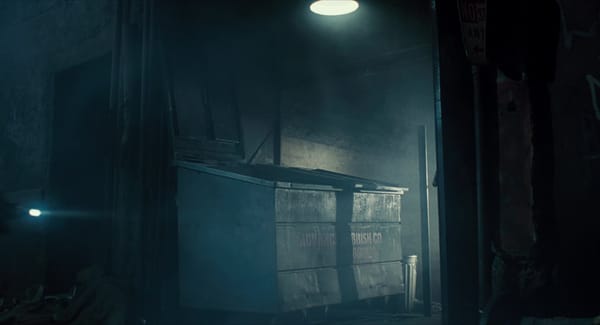 A shot of the famous "Advanced Rubbish Co" dumpster from The Terminator, lit from above with moody, smoky lighting.